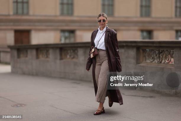 Aline Kaplan seen wearing Carolina Lemke gold sunglasses, gold earrings, Sézane white cotton ruffled button blouse / shirt, Sézane beige / brown...