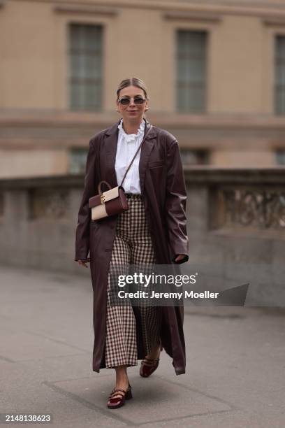 Aline Kaplan seen wearing Carolina Lemke gold sunglasses, gold earrings, Sézane white cotton ruffled button blouse / shirt, Sézane beige / brown...