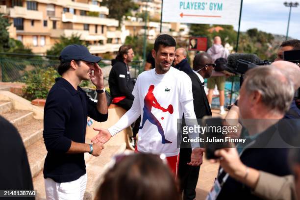 Formula 1 Motorsport Driver, Carlos Sainz Jr. And Tennis Player, Novak Djokovic of Serbia, interact on day four of the Rolex Monte-Carlo Masters at...
