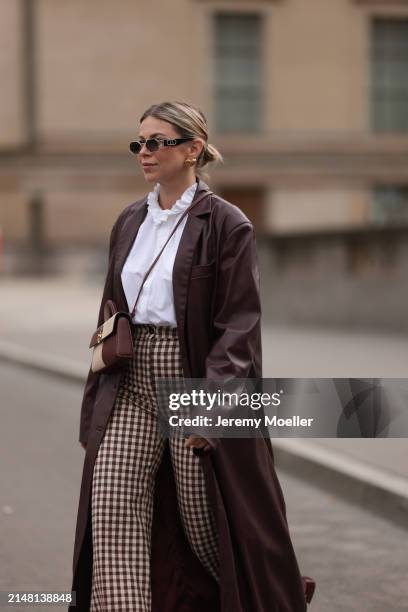 Aline Kaplan seen wearing Carolina Lemke gold sunglasses, gold earrings, Sézane white cotton ruffled button blouse / shirt, Sézane beige / brown...