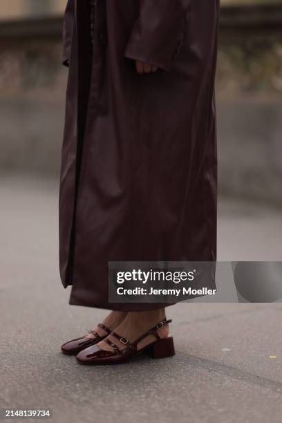 Aline Kaplan seen wearing YOOX burgundy leather long coat and Sézane burgundy shiny leather heeled ballerinas, on April 08, 2024 in Berlin, Germany.