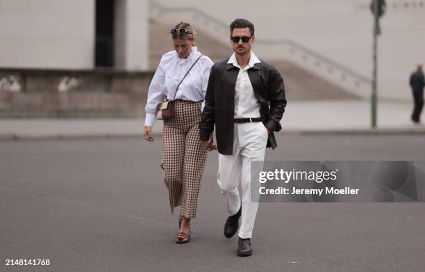 Aline Kaplan seen wearing Carolina Lemke gold sunglasses, gold earrings, Sézane white cotton ruffled button blouse / shirt, Sézane beige / brown...