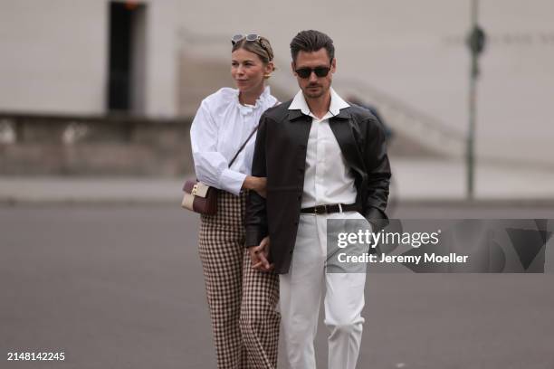 Aline Kaplan seen wearing Carolina Lemke gold sunglasses, gold earrings, Sézane white cotton ruffled button blouse / shirt, Sézane beige / brown...