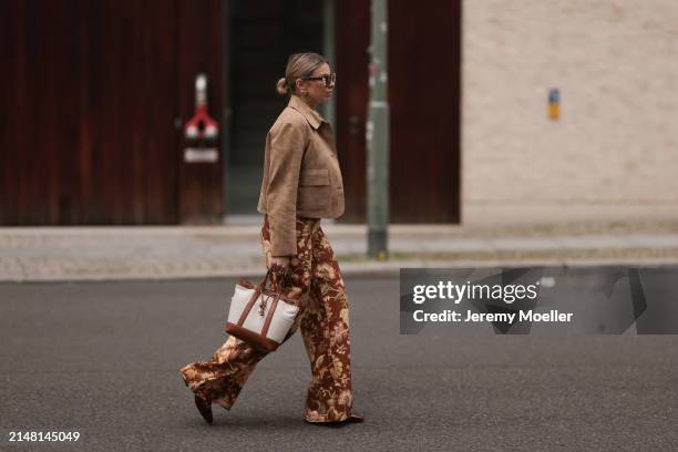 Aline Kaplan seen wearing Tibi brown sunglasses, gold earrings, Massimo Dutti beige / brown suede leather short jacket, Mango white cotton blouse,...