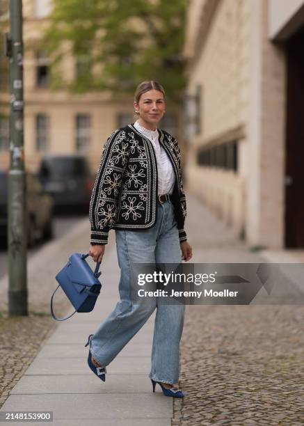 Aline Kaplan seen wearing gold heart shaped earrings, Sézane black / white flower embroidered jacket, Mango white cotton blouse, Citizen Of Humanity...