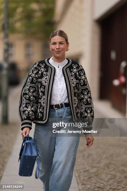 Aline Kaplan seen wearing gold heart shaped earrings, Sézane black / white flower embroidered jacket, Mango white cotton blouse, Citizen Of Humanity...