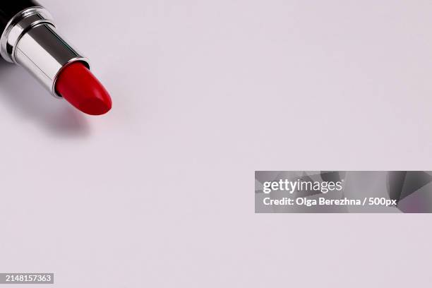 high angle view of red lipstick on white background,spain - red lipstick stick stock pictures, royalty-free photos & images