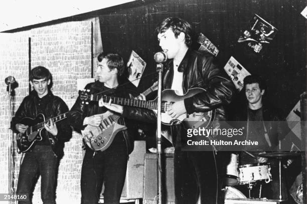 British rock group The Beatles perform in a club prior to signing their first recording contract, Liverpool, England, 1962. L-R: George Harrison,...