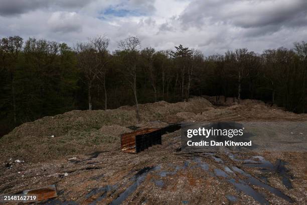 Illegally dumped commercial waste covers a cleared area in Hoads Wood on April 09, 2024 in Ashford, Kent. Hoads wood in Kent is a 199 acre site of...