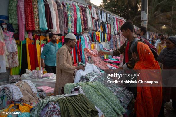 Muslim family purchases clothes on the street ahead of Eid al-Fitr on April 10, 2024 in Bengaluru, India. Muslims worldwide observe the Eid Al-Fitr...