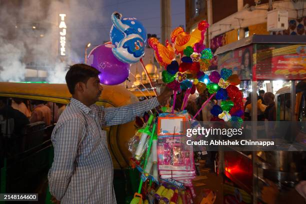 Balloon seller hawks his wares on a busy street ahead of Eid al-Fitr on April 10, 2024 in Bengaluru, India. Muslims worldwide observe the Eid Al-Fitr...