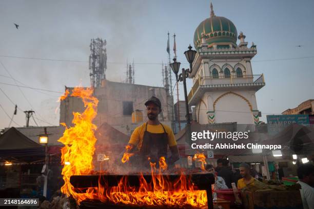 Muslim man prepares seekh kebabs on skewers on a street ahead of Eid al-Fitr on April 10, 2024 in Bengaluru, India. Muslims worldwide observe the Eid...