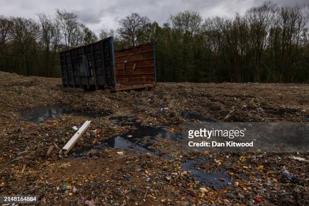 Illegally dumped commercial waste covers a cleared area in Hoads Wood on April 09, 2024 in Ashford, Kent. Hoads wood in Kent is a 199 acre site of...