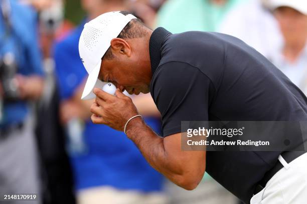 Tiger Woods of the United States lines up a ball drop near the practice green during a practice round prior to the 2024 Masters Tournament at Augusta...