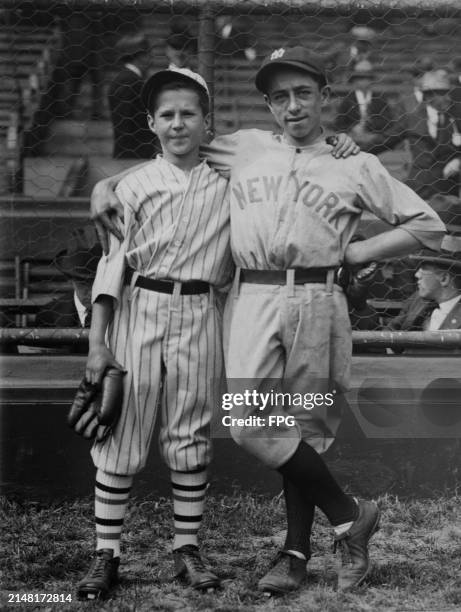 Batboys and team mascots, Billie Craig of the New York Giants and Eddie Bennett of the New York Yankees, pose for a photograph before Game 1 of the...