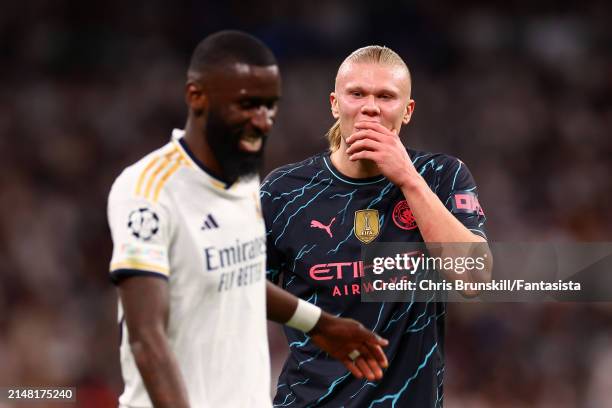 Antonio Rudiger of Real Madrid shares a laugh with Erling Haaland of Manchester City during the UEFA Champions League quarter-final first leg match...