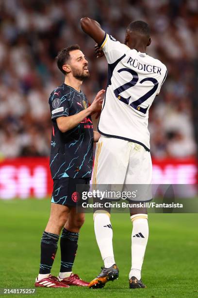 Antonio Rudiger of Real Madrid clashes with Bernardo Silva of Manchester City during the UEFA Champions League quarter-final first leg match between...