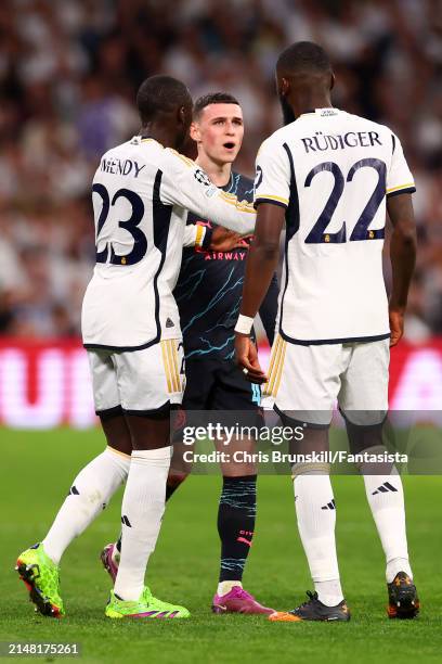 Antonio Rudiger of Real Madrid clashes with Phil Foden of Manchester City during the UEFA Champions League quarter-final first leg match between Real...