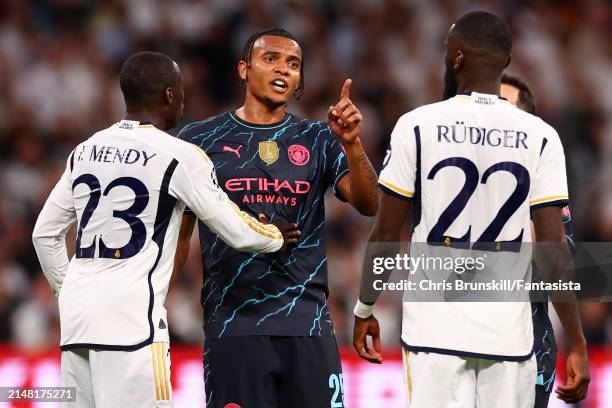 Antonio Rudiger of Real Madrid clashes with Manuel Akanji of Manchester City during the UEFA Champions League quarter-final first leg match between...