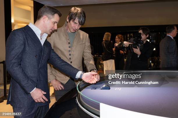 Professor Brian Cox and IWC Schaffhausen CEO Chris Grainger-Herr at the IWC Schaffhausen booth at Watches and Wonders Geneva on April 10, 2024 in...