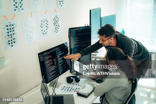 Hispanic Programmers Collaborating on Software Development in a Modern Office Setting Hispanic Programmers Collaborating on Software Development in a Modern Office Setting