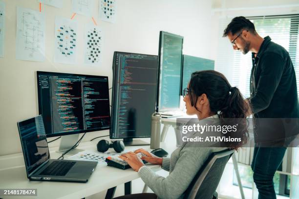 two hispanic programmers collaborating in modern office - machine learning engineer stock pictures, royalty-free photos & images