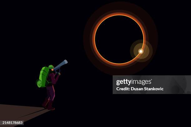 man watching the solar eclipse in the mountains - total solar eclipse stock illustrations