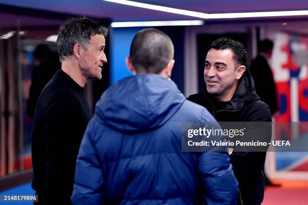 Luis Enrique, Head Coach of Paris Saint-Germain, and Xavi, Head Coach of FC Barcelona, interact prior to the UEFA Champions League quarter-final...