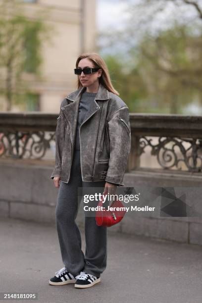 Sonia Lyson seen wearing Linda Farrow x Magda Butrym black sunglasses, Sporty & Rich grey cashmere sweater, matching Sporty & Rich grey cashmere grey...