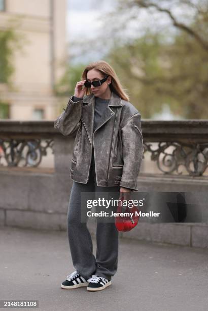 Sonia Lyson seen wearing Linda Farrow x Magda Butrym black sunglasses, Sporty & Rich grey cashmere sweater, matching Sporty & Rich grey cashmere grey...