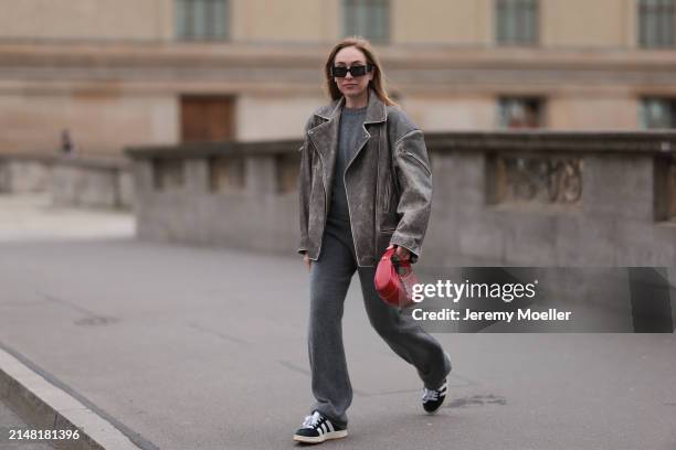 Sonia Lyson seen wearing Linda Farrow x Magda Butrym black sunglasses, Sporty & Rich grey cashmere sweater, matching Sporty & Rich grey cashmere grey...