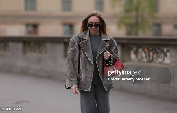 Sonia Lyson seen wearing Linda Farrow x Magda Butrym black sunglasses, Sporty & Rich grey cashmere sweater, matching Sporty & Rich grey cashmere grey...