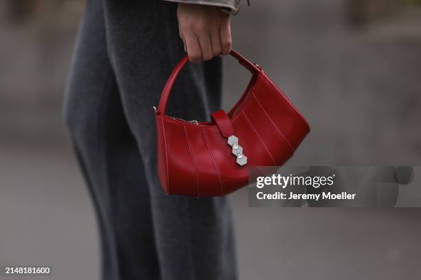 Sonia Lyson seen wearing Sporty & Rich grey cashmere grey jogging pants and Mietis red leather handbag, on April 10, 2024 in Berlin, Germany.