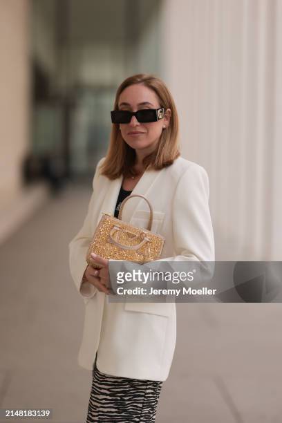 Sonia Lyson seen wearing Gucci black sunglasses, Loewe black cotton logo embroidered top, H&M white / black zebra animal print pants, Zara white...