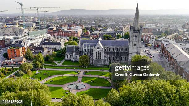 aerial view of cathedral and park from saint patrick's park-dublin, aerial view of historic st. patrick's cathedral in the heart of ireland, christ church cathedral, aerial view of people walking in saint patrick park, public park fountain - christ-church-cathedral-ireland stock pictures, royalty-free photos & images