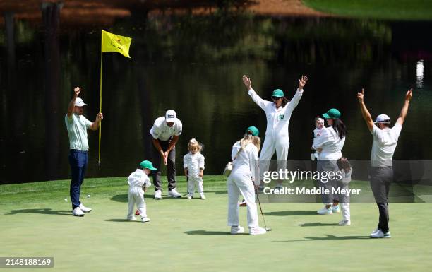 Nick Taylor of Canada, Adam Hadwin of Canada, and Corey Conners of Canada celebrates with their families on the ninth green during the Par Three...