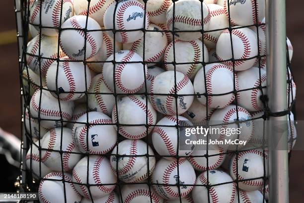 Balls used for batting practice are seen in front of the Boston Red Sox dugout before a game against the Los Angeles Angels in a Major League...
