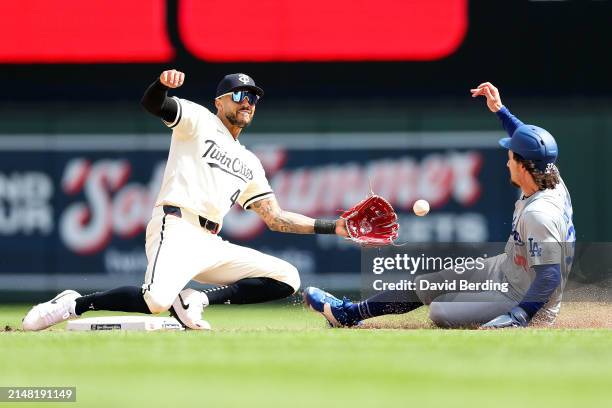 Carlos Correa of the Minnesota Twins tags out James Outman of the Los Angeles Dodgers on a steal attempt at second base in the sixth inning at Target...