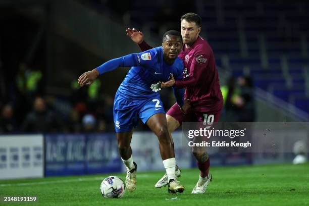 Ethan Laird of Birmingham City runs with the ball whilst under pressure from Aaron Ramsey of Cardiff City during the Sky Bet Championship match...