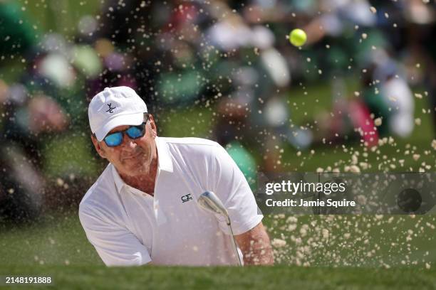 Nick Faldo of England plays a shot from a bunker on the second hole during the Par Three Contest prior to the 2024 Masters Tournament at Augusta...