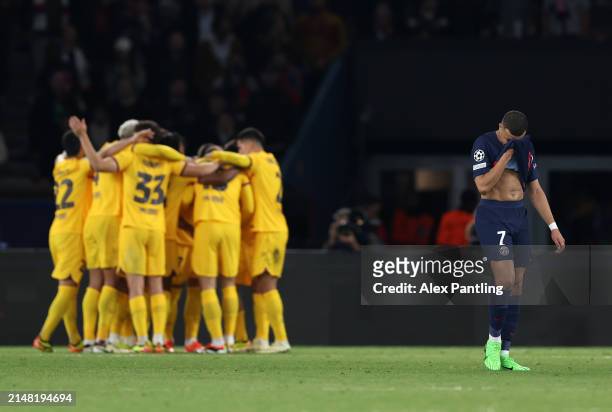 Kylian Mbappe of Paris Saint-Germain reacts as Andreas Christensen of FC Barcelona celebrates scoring his team's third goal during the UEFA Champions...