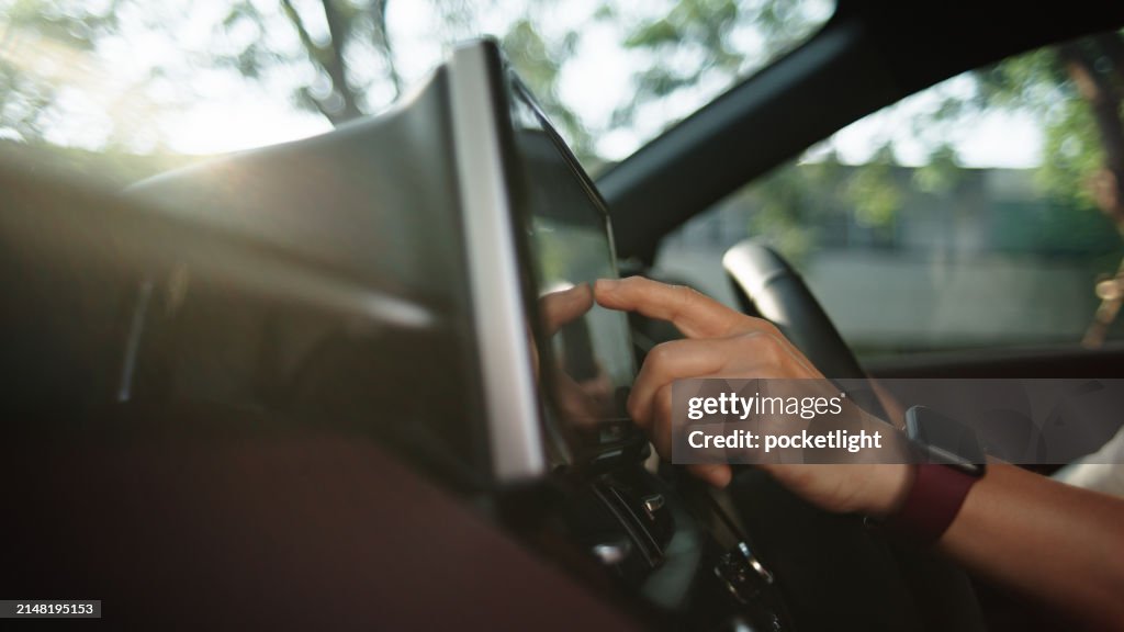 Woman checking map gps or control music radio in car.