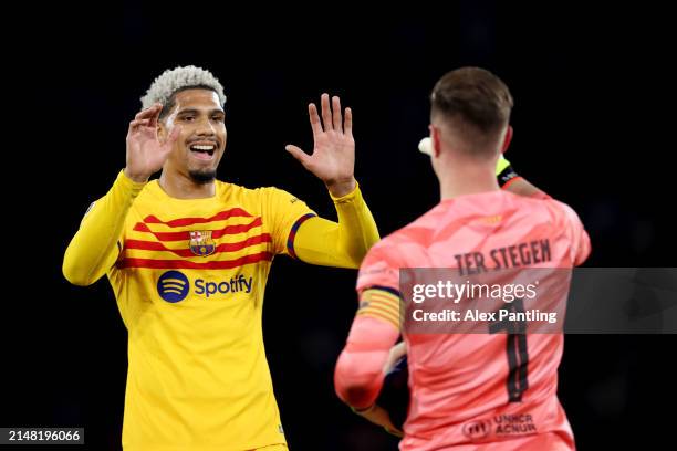 Ronald Araujo and Marc-Andre ter Stegen of FC Barcelona embrace following victory in the UEFA Champions League quarter-final first leg match between...