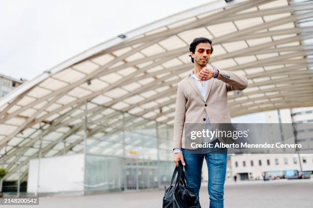 businessman leaving the train station - checking the time stock pictures, royalty-free photos & images