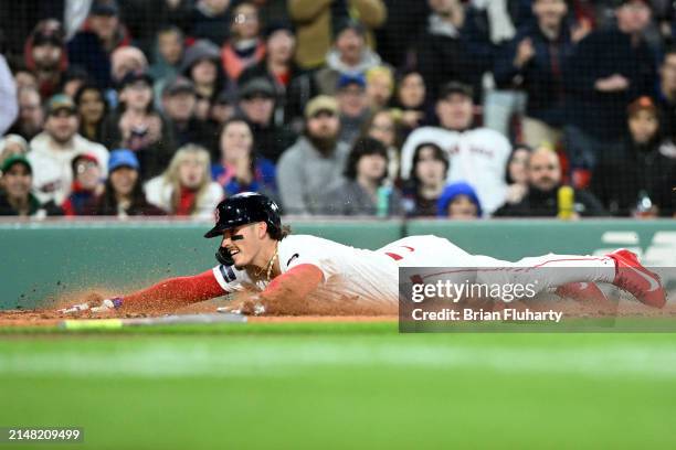 Jarren Duran of the Boston Red Sox slides safely into home during the third inning of a game against the Baltimore Orioles at Fenway Park on April...