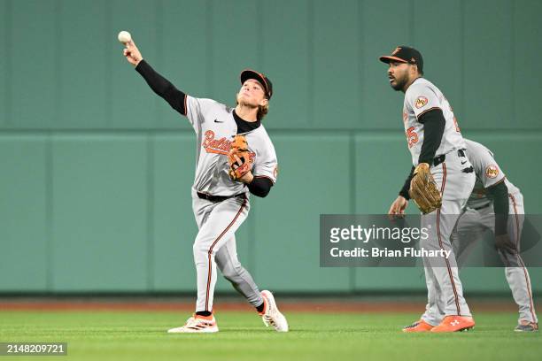 Jackson Holliday of the Baltimore Orioles throws to home during the third inning of his MLB debut against the Boston Red Sox at Fenway Park on April...