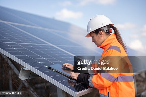 Female Engineer with Tablet in Solar Power Plant. Energy Saving Solutions. Female Engineer with Tablet in Solar Power Plant. Energy Saving Solutions.
