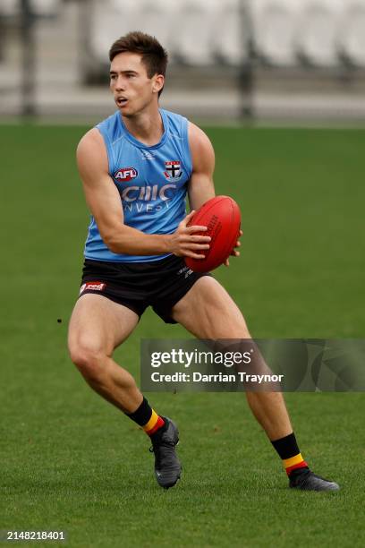 Cooper Sharman of the Saints runs with the ball during a St Kilda Saints AFL training session at RSEA Park on April 11, 2024 in Melbourne, Australia.