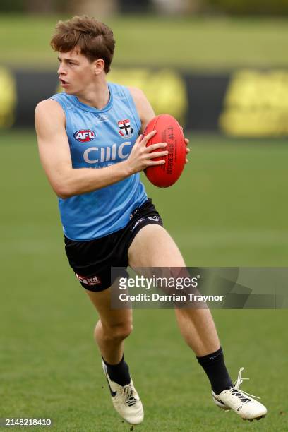 Mattaes Phillipou of the Saints runs with the ball during a St Kilda Saints AFL training session at RSEA Park on April 11, 2024 in Melbourne,...