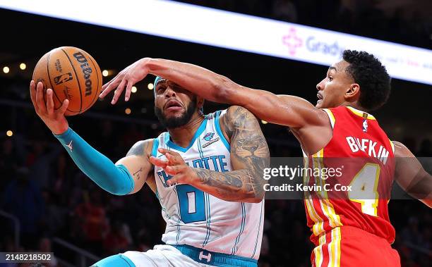 Miles Bridges of the Charlotte Hornets scores the game-winning basket as he drives against Kobe Bufkin of the Atlanta Hawks during the fourth quarter...